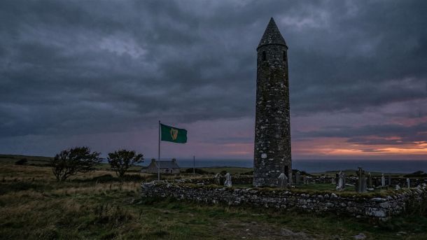 Ancient Irish stone tower against a stormy sky, representing Irish heritage and the fighting spirit of Celtic identity