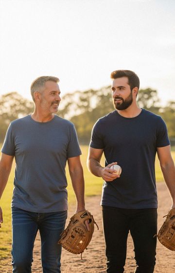 Middle-aged father playing catch with his adult son.